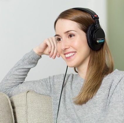 smiling women in headphones